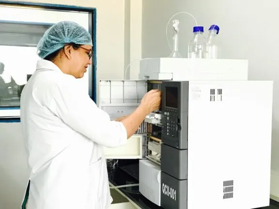 A flavour research analyst working with analytical equipment